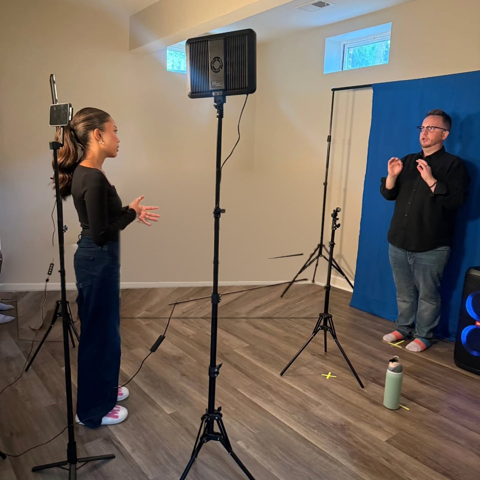Tony Cimino-Johnson coaching a teenage student through a monologue in a private lesson studio, with lights, a tripod camera and marked spots on the floor
