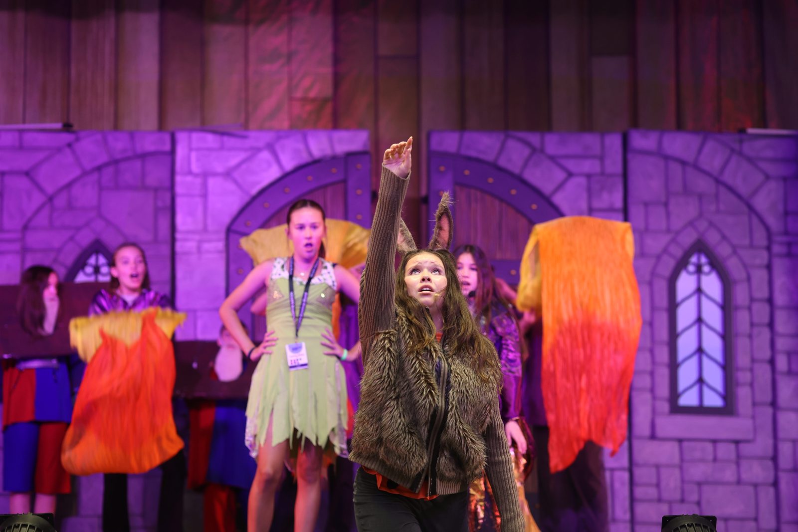 A camper performing as Donkey with the dragon behind
